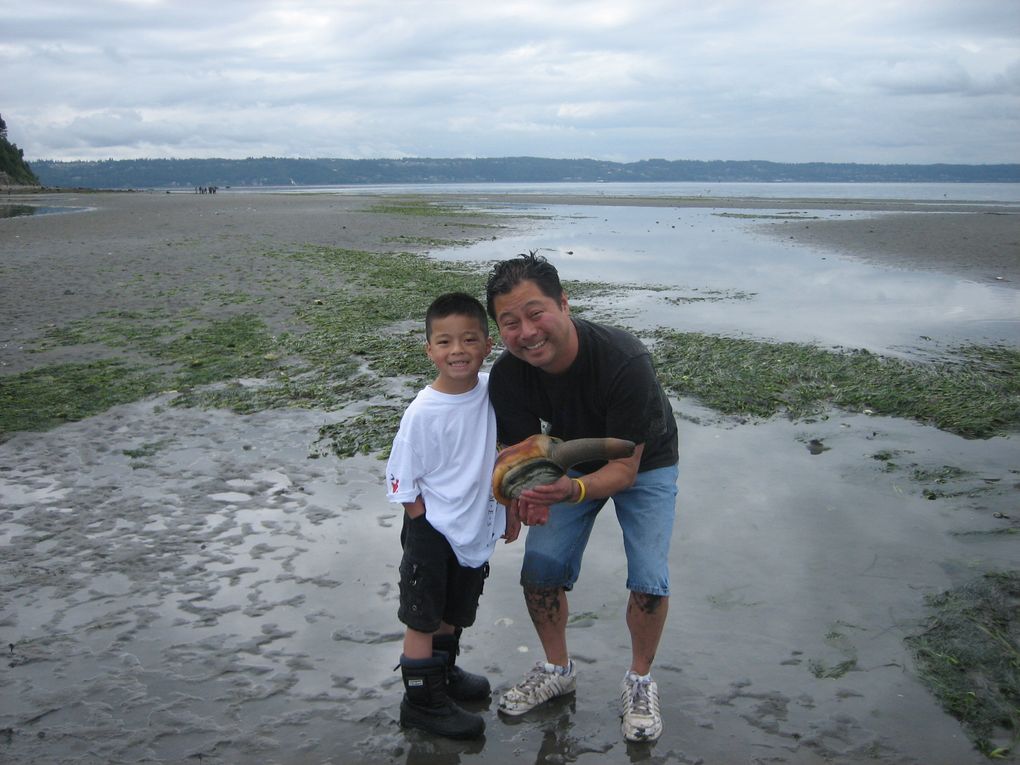 Seattle Times fishing reporter Mark Yuasa and son Tegan Yuasa holding a nice geoduck.