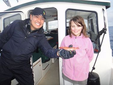 Ryan Nakata of Mercer Island holds a spot shrimp caught in Puget Sound.