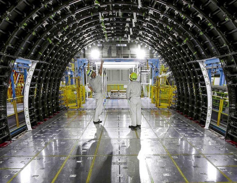 Two workers inside Kawasaki Heavy Industries plant in Nagoya inspect the inside of a 787 carbon-fiber composite fuselage barrel. The Boeing supplier in Japan would eventually like to be a builder of a complete aircraft. (Boeing) Two workers inside Kawasaki Heavy Industries plant in Nagoya inspect the inside of a 787 carbon-fiber composite fuselage barrel. The Boeing supplier in Japan would eventually like to be a builder of a complete aircraft. (Boeing)