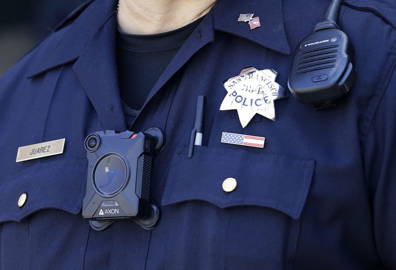 In this May 13, 2017 photo, San Francisco Police officer Joe Juarez wears a body camera while patrolling outside of AT&T Park. San Francisco is one of five departments among those in the 20 biggest U.S. cities with rules requiring the cameras for uniformed officers working outside their regular hours. (AP Photo/Jeff Chiu) 