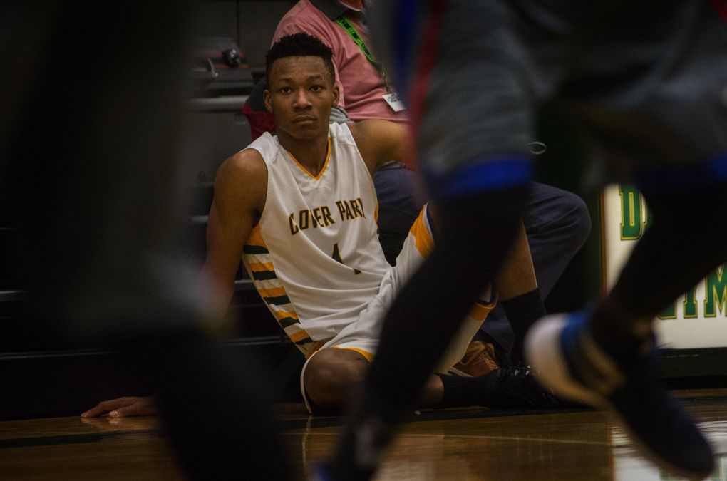 Clover Park High School basketball player Semaj Booker (#1) watches the action shortly before he goes back in at the Clover Park Warrior’s playoff game against the Washington Patriots at Foss High School in Tacoma, WA, Monday, February 15, 2016. (Ellen M. Banner/The Seattle Times)
