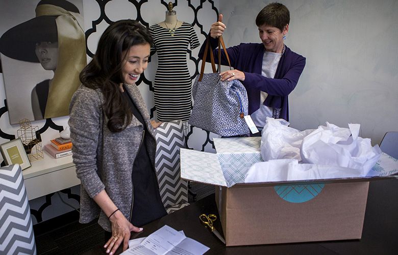 Stitch Fix CEO Katrina Lake, left, and San Jose Mercury reporter Dana Hull look over items picked out for Hull by Margaret, not pictured, a stylist at Stitch Fix in San Francisco, Calif., March 5, 2014. (John Green/Bay Area News Group/MCT)