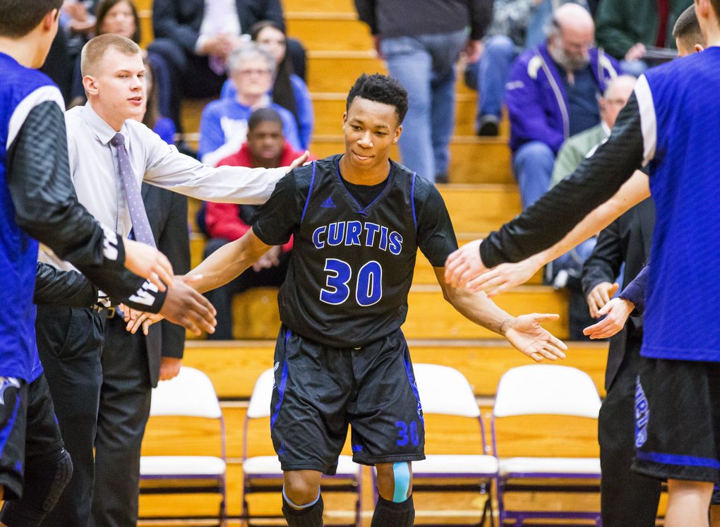 Curtis HS forward Semaj Booker is introduced at the start of a district playoff game with Federal Way. (DEAN RUTZ / The Seattle Times)