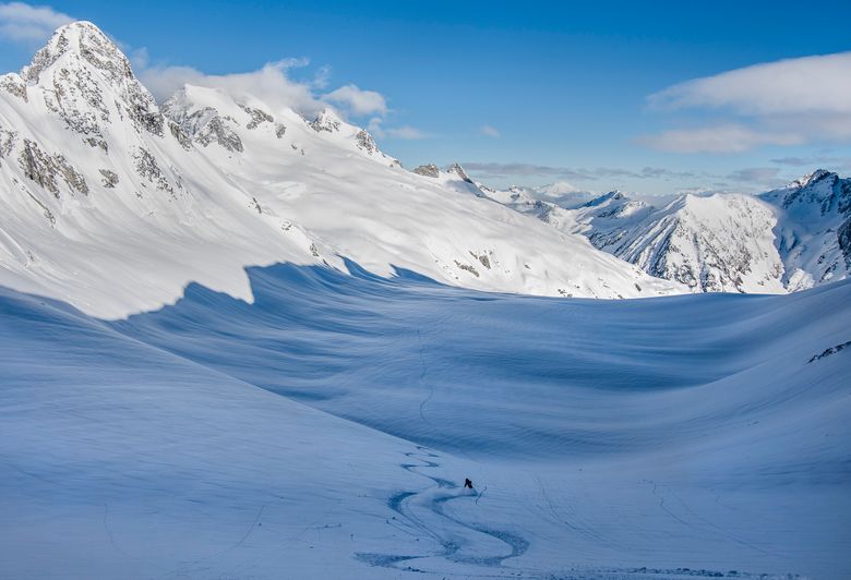 Forest McBrian follows Trevor Kostanich’s ski track down from camp on the Upper Chickamin Glacier, near Dome Peak. (Scott Rinckenberger / www.scottrinck.com) 