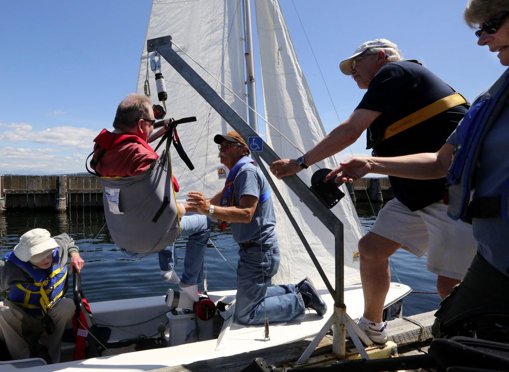 Faron Shanklin is able to get into and out of a small sailboat with a Hoyer lift attached to a dock at Seattle’s Leschi Marina. (Alan Berner/The Seattle Times)