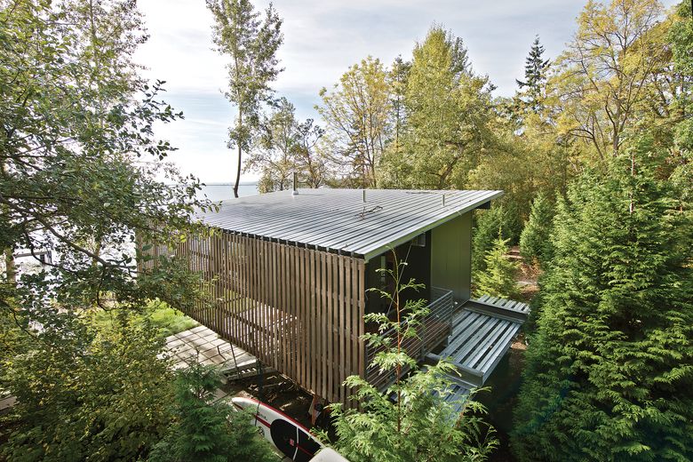 The back of the eHAB Cabin, reached by a cable tram designed by project architect Josh Johns, or by a steep pathway, faces a 40-foot bluff to the north. The full-length slat screen on the east side is for privacy and shading, while large front and rear overhangs shelter the cabin from summertime sun and allow passive heating in the winter. “We used the stair and screen to capture the entry,” says architect Eric Cobb. “It’s a whole series of layers so a box doesn’t feel like a box.”  (Courtesy Michael Cole / via The Taunton Press)