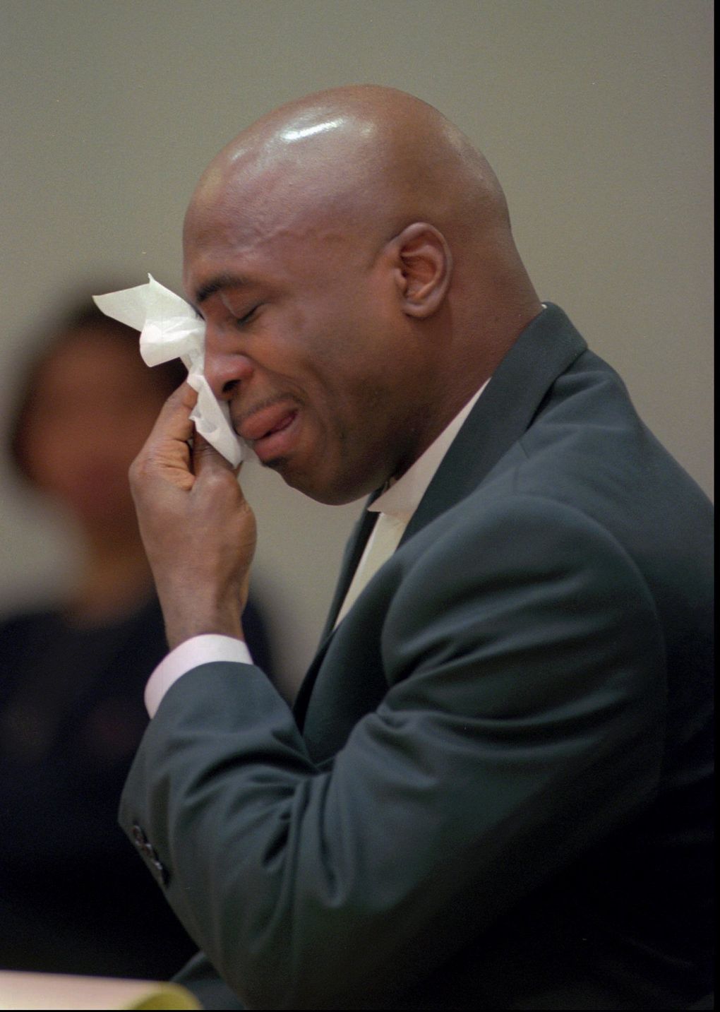 Former Seahawks running back Lamar Smith wipes his tears after being sentenced on Feb. 13, 1998 in Kent to four months in jail and 30 days of community service, which was deducted from the jail term, for the 1994 car accident that paralyzed teammate Mike Frier. Smith pleaded guilty to vehicular assault, averting a second trial, after his 1996 trial ended in a mistrial. (ROBERT SORBO/AP)