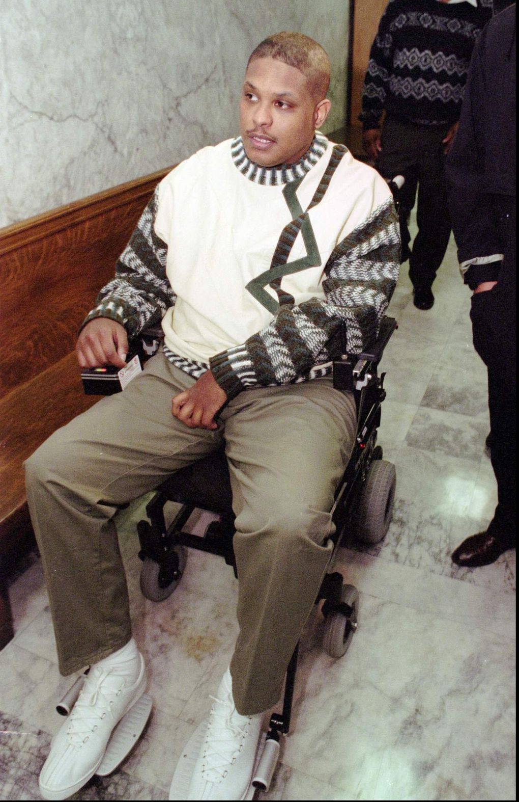 Mike Frier arrives at Superior Court in Seattle in 1996. Frier testified against former teammate Lamar Smith, who was charged with vehicular assault in the Dec. 1, 1994, accident that paralyzed Frier. (ROBERT SORBO/AP)