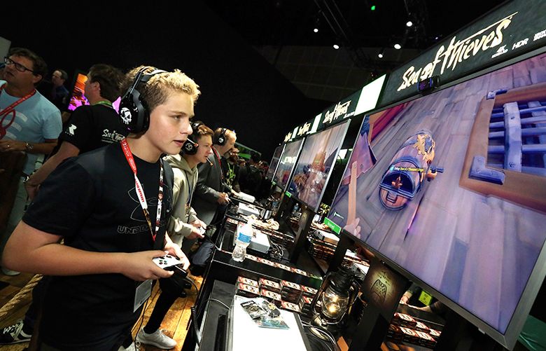IMAGE DISTRIBUTED FOR MICROSOFT – A young fan gets his hands on “Sea of Thieves” at the Xbox booth at E3 2017 in Los Angeles on Tuesday, June 13, 2017. (Photo by Casey Rodgers/Invision for Microsoft/AP Images)