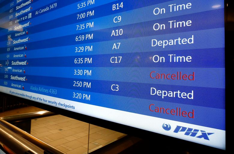 At Phoenix Sky Harbor International Airport, departure signs show regional jet cancellations and American Airlines says seven regional flights have been delayed and 43 have been canceled because of a heat wave as temperatures climb to near-record highs Tuesday, June 20, 2017, in Phoenix. (AP Photo/Ross D. Franklin)