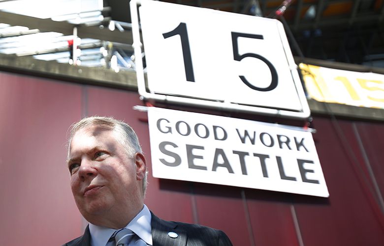 139174– WAGE VOTE– 06/02/2014Seattle Mayor Ed Murray walks offstage after his remarks, a large sign congratulating Seattle in the background, outside City Hall after the Seattle City Council unanimously adopted a plan to raise the minimum pay of Seattle workers to $15 an hour over the next three to seven years, on Monday, June 2, 2014. This vote will provide the city with the highest minimum wage in the country.