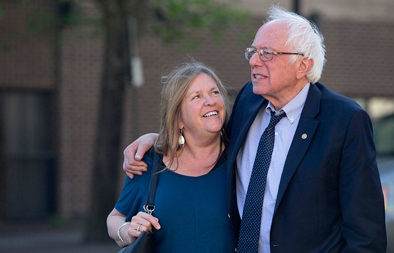 FILE – In this April 19, 2016, file photo, Democratic presidential candidate Sen. Bernie Sanders, I-Vt., and his wife Jane take a walk in State College, Pa. A Republican lawyer pushing the allegations that Sen. Bernie Sanders’ wife committed bank fraud to win a loan while president of a now-defunct Vermont college has a long history of filing complaints against left-of-center politicians in the state. (AP Photo/Mary Altaffer, File)