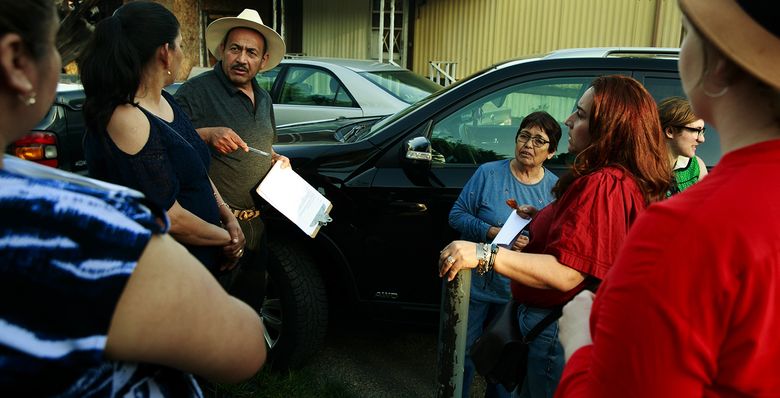 Cruz Medina, in hat, talks during a recent meeting with residents who live in The Firs Mobile Home Park in SeaTac. The residents, who are mostly Spanish-speaking, are trying to fight displacement that would be caused by a planned hotel development. Many families say their rent would double or triple if they had to leave. (Erika Schultz/The Seattle Times)
