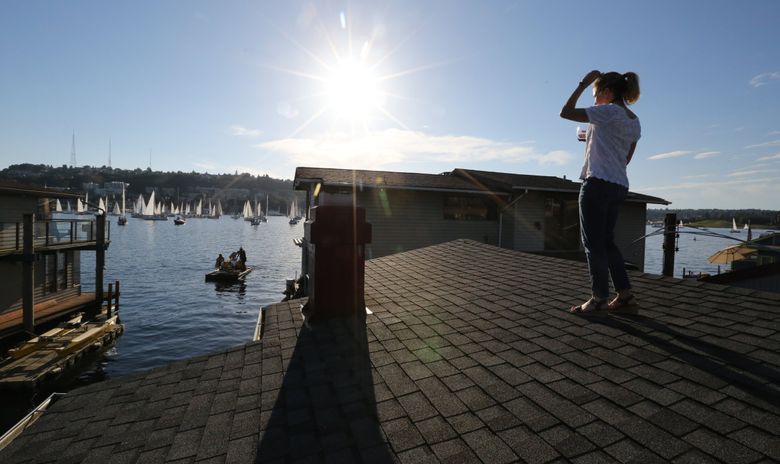 From atop her houseboat, Anne Bonn has a great view of Lake Union and a Tuesday night Duck Dodge, a zany Lake Union tradition for decades. (Alan Berner / The Seattle Times)