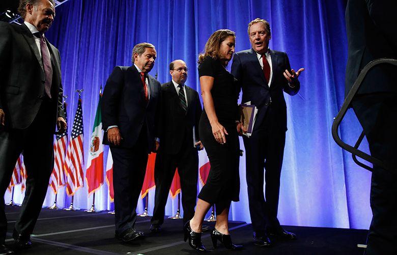 Canadian Chief Negotiator Steve Verheul, left, walks next to Canadian Ambassador to the U.S. David McNaughton, and U.S. Chief Negotiator John Melle, as Canadian Foreign Affairs Minister Chrystia Freeland, talks with U.S. Trade Representative Robert Lighthizer, right, as they leave the stage after attending a news conference Wednesday, Aug. 16, 2017, at the start of NAFTA renegotiations in Washington. (AP Photo/Jacquelyn Martin)