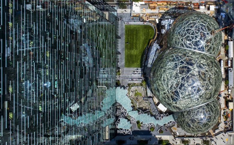 Viewed from above, the Amazon Spheres sit before Day 1, the dominant building owned by the company in downtown Seattle.  (Kjell Redal/The Seattle Times)