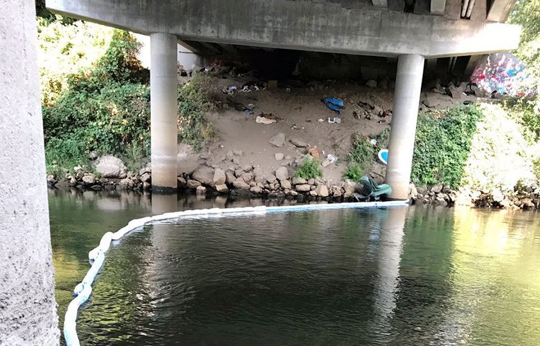 Crews from Renton, Kent, and Tukwilla are containing a sheen on the Green River in an industrial area near Kent on Tuesday, August 29, 2017. (Courtesy of Renton Firefighters / Twitter)