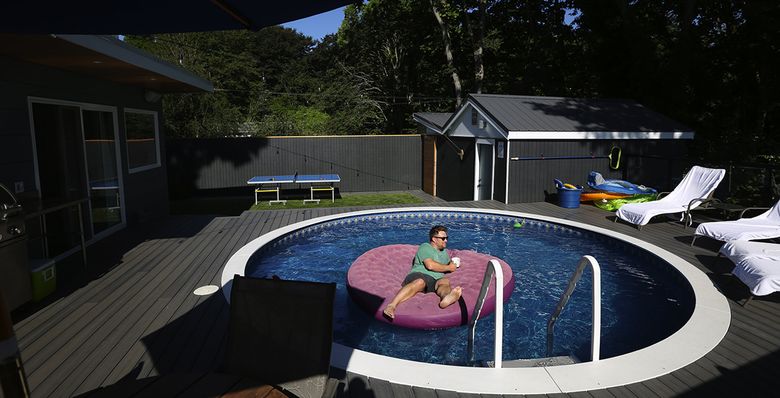 Sam Allard, and his wife, Heather, say spending time in their Columbia City backyard is like going to Palm Springs, without leaving home. (Ken Lambert/The Seattle Times) 