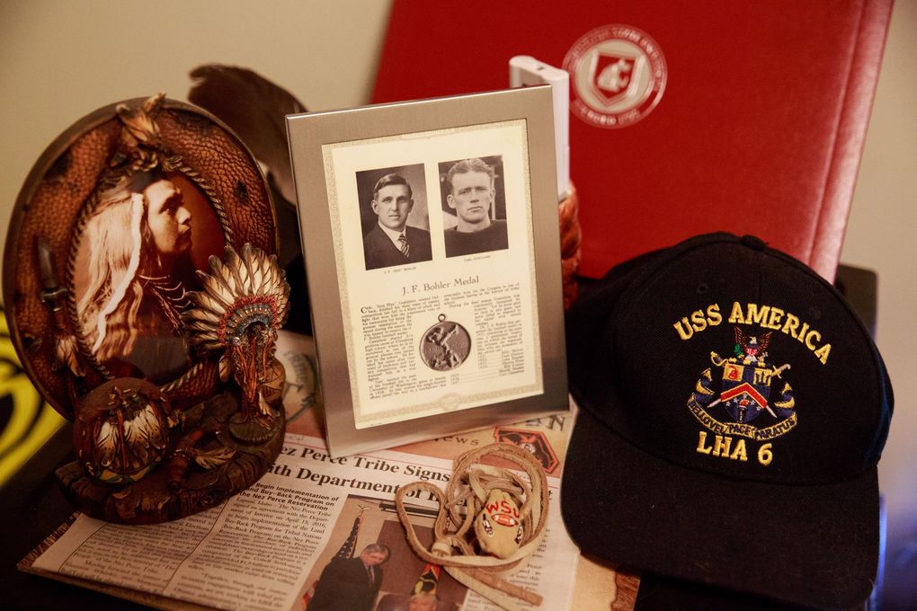 Linebacker Peyton Pelluer’s great-grandfather Carl Gustafson won the Bohler Medal when he was at WSU in the 1920s. Next to a framed picture commemorating Gustafson’s Bohler Medal, Pelluer keep a memento that reflects his Native American heritage inside his room in Pullman, Wash. Wednesday July 5, 2017. (Erika Schultz / The Seattle Times)