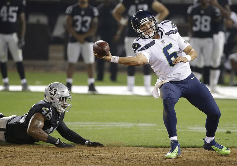 Seattle Seahawks quarterback Austin Davis (6) passes in front of Oakland Raiders linebacker LaTroy Lewis (46) during the second half of an NFL preseason football game in Oakland, Calif., Thursday, Aug. 31, 2017. (AP Photo/Eric Risberg) 