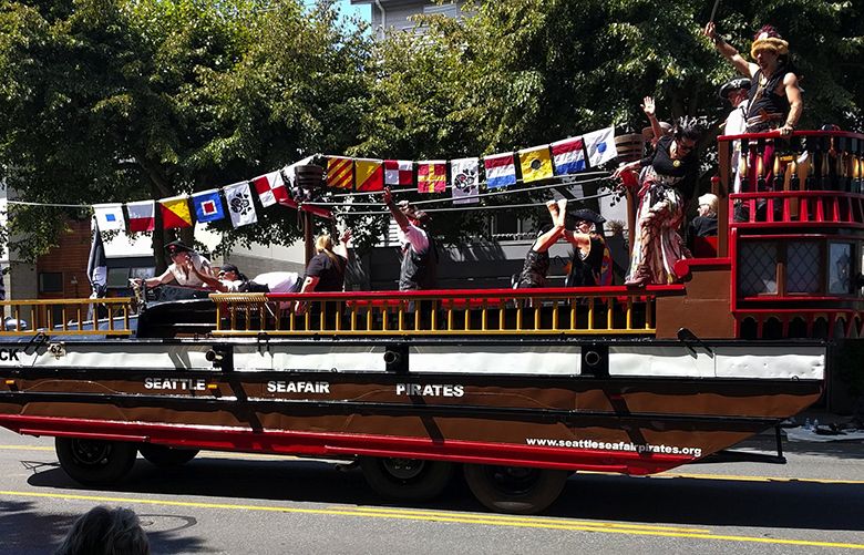 The Seafair Pirates participate in the West Seattle Grand Parade on July 23, 2016. The nautical flags across the top of the ship each represent a letter, which can be decoded to find a message: “Show us your tits”.The pirates say they recently changed the flags to now spell the group’s name.