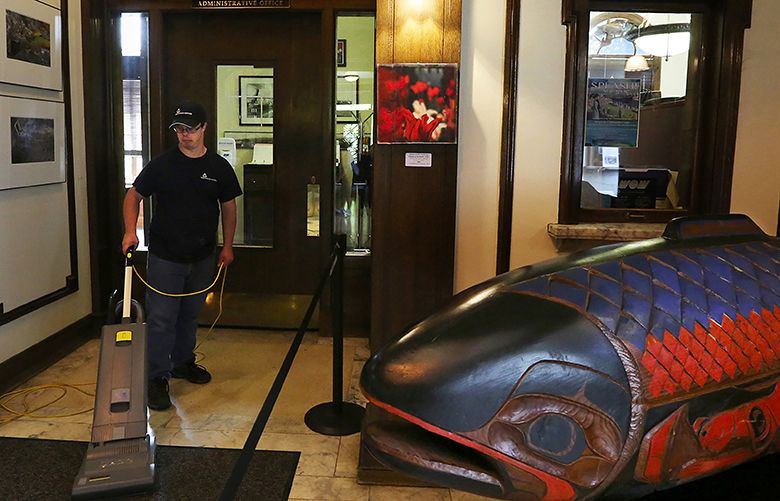 Chris Wicklander CQ is a custodian at the Ballard Locks where he gets paid below minimum wage, here vacuuming the lobby of the Administration Building.
He has Down Syndrome. Thursday August 17, 2017