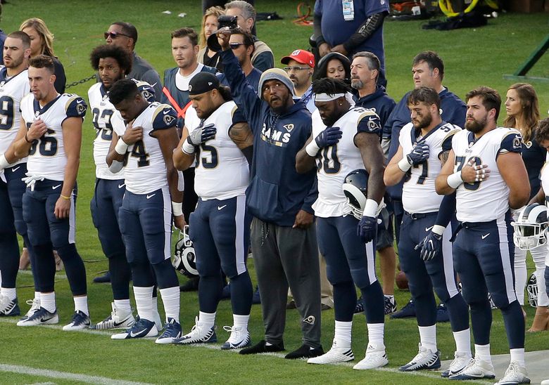 Raiders' Marshawn Lynch sits during national anthem before preseason game