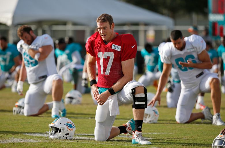 Miami Dolphins quarterback Ryan Tannehill (17) watches from the sidelines  while rocking the be…