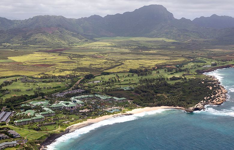 The Grand Hyatt Resort, bottom left, sits about a mile and a half away from a proposed dairy farm, center, in Poipu, Hawaii, May 10, 2017. The founder of eBay wants to build a dairy farm on the island of Kauai, but some residents who object are teaming up with owners of resorts that line the island’s famous beaches to try to block the project. (Marco Garcia/The New York Times)