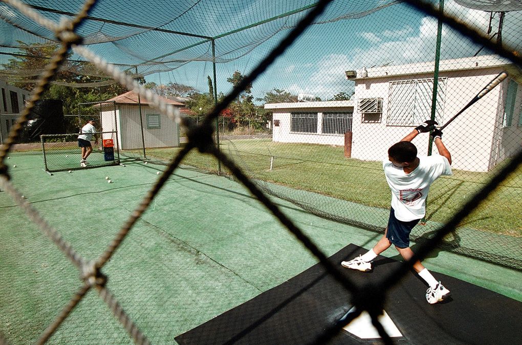 Edgar Martinez’s house in the Maguayo sector of the Town of Dorado, Puerto Rico is pictured in 2001. Karlos Rivera, cousin of Edgar, during batting practice in the backyard of his house. (Juan Luis Martinez / Special for The Seattle Times)