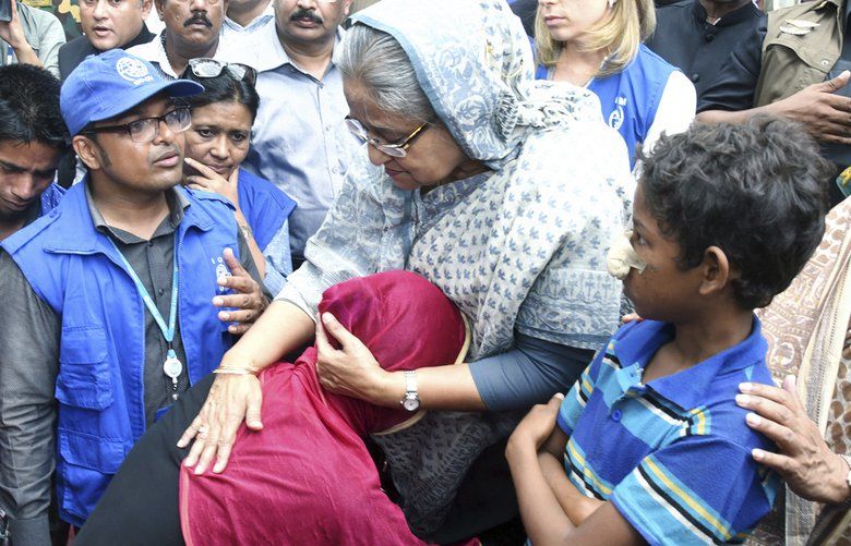 Bangladeshi Prime Minister Sheikh Hasina, center, meets with Rohingya Muslims at Kutupalong refugee camp, near the border town of Ukhia, Bangladesh, Tuesday, Sept. 12, 2017. Hasina visited the struggling refugee camp that has absorbed some of the hundreds of thousands of Rohingya who fled recent violence in Myanmar, a crisis she said left her speechless. (AP Photo/Saiful Kallol) DHA101 DHA101