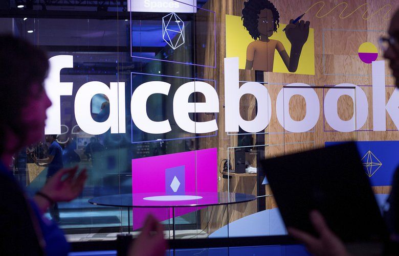 FILE – In this April 18, 2017, file photo, conference workers speak in front of a demo booth at Facebook’s annual F8 developer conference, in San Jose, Calif.(AP Photo/Noah Berger, File) 