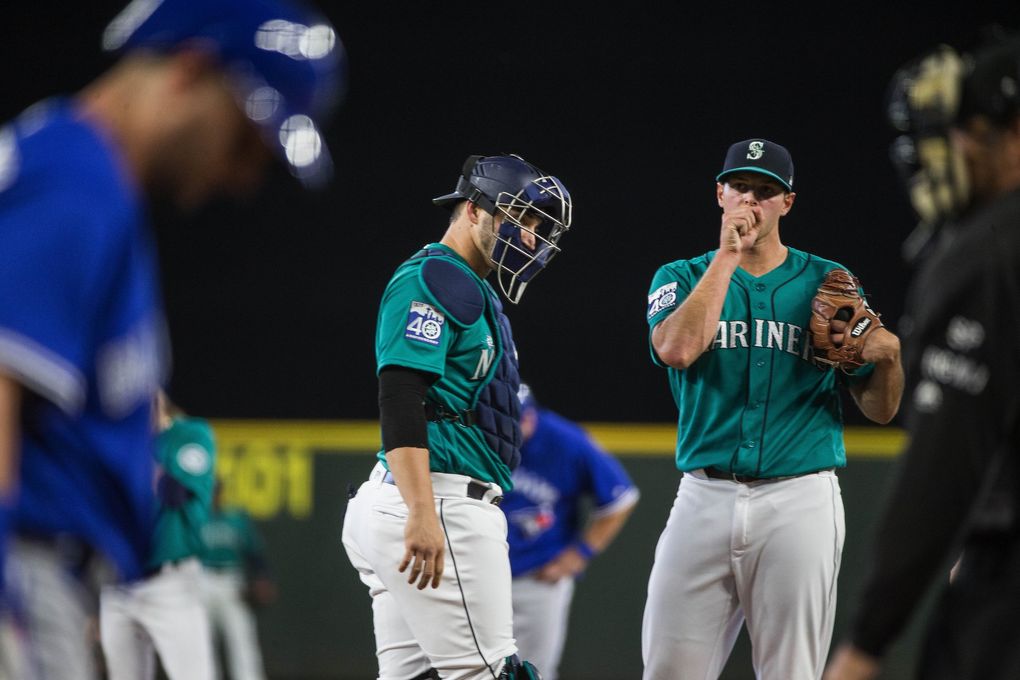 With runners on in the first inning, Mike Zunino helps starting pitcher Sam Gaviglio get out of the frame without giving up a run. The Toronto Blue Jays played the Seattle Mariners Friday, June 9, 2017 at Safeco Field in Seattle. (Dean Rutz / The Seattle Times)