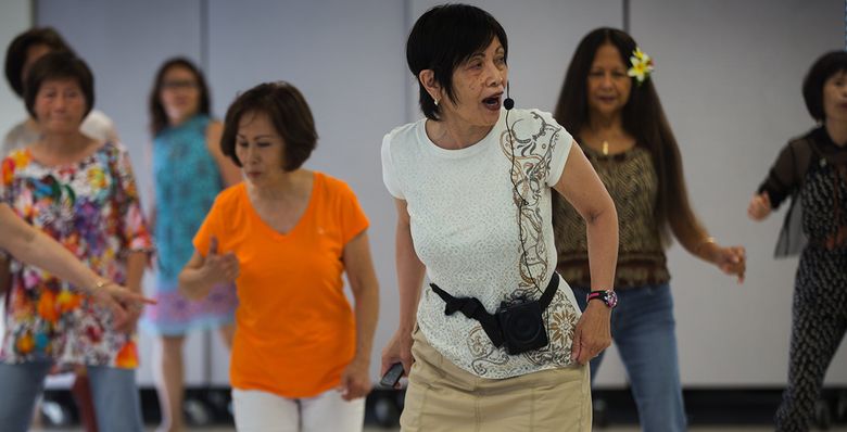 Elizabeth Woodarski leads a class in line dancing at the Korean Women’s Association in Tacoma. (Ellen M. Banner/The Seattle Times)