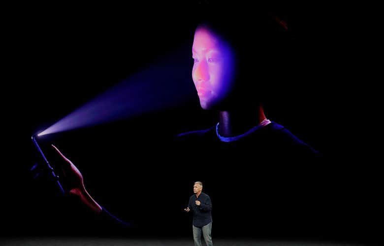Phil Schiller, Apple’s senior vice president of worldwide marketing, announces features of the new iPhone X at the Steve Jobs Theater on the new Apple campus on Tuesday, Sept. 12, 2017, in Cupertino, Calif. (AP Photo/Marcio Jose Sanchez)