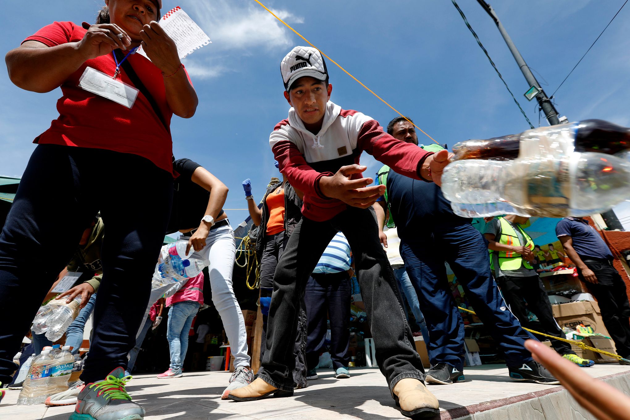 Bystanders Gather Around Collapsed Shopping Mall in Mexico City