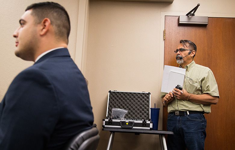 Jorge Villasenor translates a City Council meeting for Spanish-speaking attendees at Yakima City Hall in downtown Yakima, Wash., Tuesday, Sept. 19, 2017. Although translation services are available at all City Council business meetings, residents say audio in the headsets makes it difficult to hear what is being discussed and that translated meeting agendas are not provided. (SHAWN GUST/Yakima Herald-Republic)