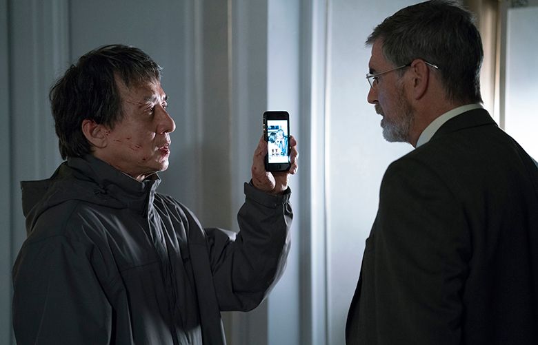 (Left to Right) Jackie Chan as Quan and Pierce Brosnan as Hennessy in hotel suite in THE FOREIGNER