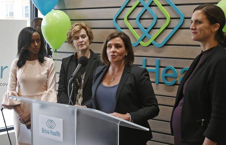 In this Oct. 26, 2017, photo, Allison O’Toole, second from right, speaks to the media at the new offices of Briva Health, MNsure’s largest enrollment partner, in Minneapolis. Health care consumers in most of the country are encountering a world of confusion and chaos as the open enrollment period to sign up for coverage approaches. The outlook is decidedly different in the 12 states that operate their own marketplaces. California, Colorado, Minnesota and other states that operate autonomous exchanges are pulling out all the stops to inform consumers. Also shown, from left, Hodan Guled, chief executive officer of Briva Health, Minneapolis Major Betsy Hodges and at right, Emily Piper, commissioner of Minnesota Human Services. (AP Photo/Jim Mone) MP102 MP102
