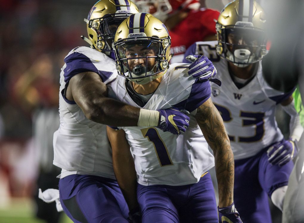 Washington cornerback Byron Murphy celebrates his second interception in his UW debut against Rutgers. (Dean Rutz/The Seattle Times)