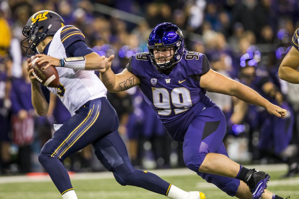 Washington defensive lineman Greg Gaines sacks California quarterback Ross Bowers for a loss of 17 yards. (Bettina Hansen / The Seattle Times)