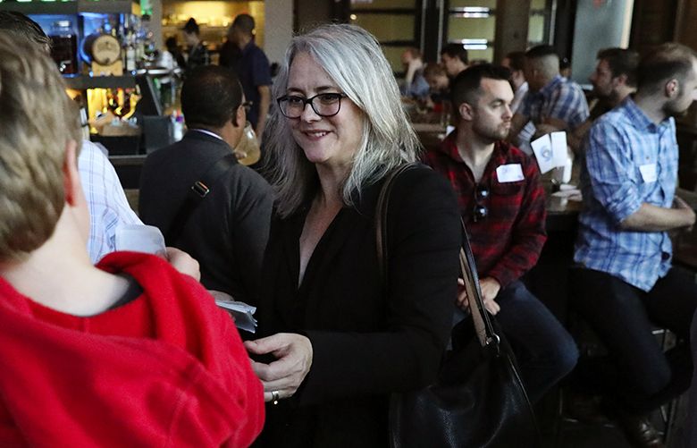Seattle mayoral candidate Cary Moon greets supporters at a get-out-the-vote event with transit advocates at a Capitol Hill bar, Wednesday, Oct. 4, 2017, in Seattle.  203735