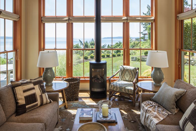 There’s a nice view of Puget Sound from the den of Jeanie Ketcham’s family home that was rebuilt after a 2012 fire. (Steve Ringman/The Seattle Times)