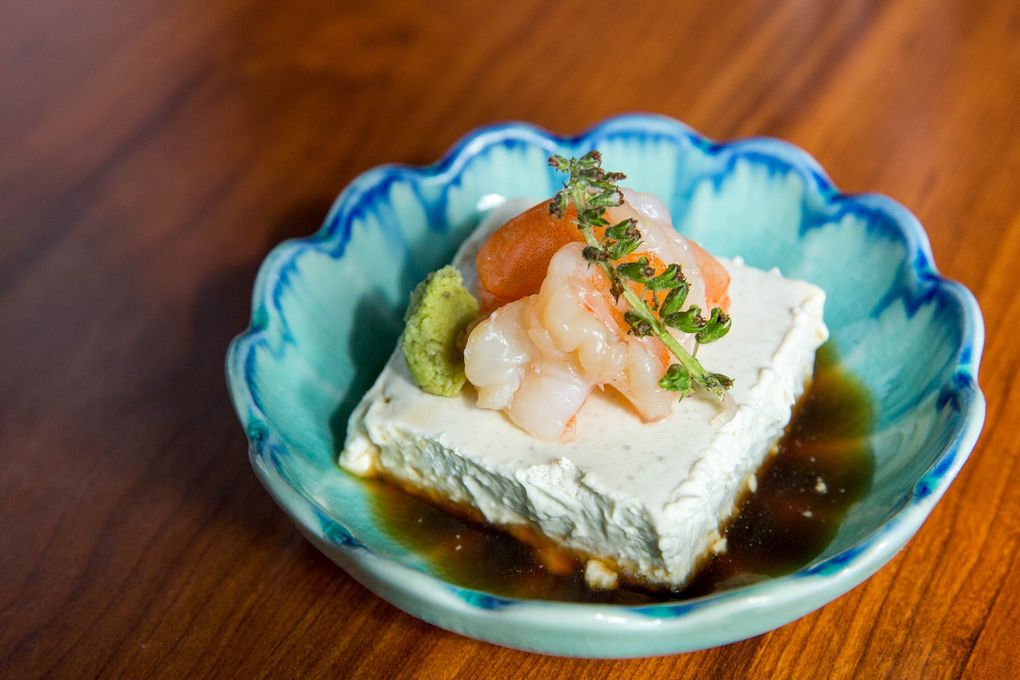 Kamonegi’s foie gras, rejiggered to look like a tofu square, comes with sake-poached shrimp and a dollop of wasabi served with dashi sauce. (Courtney Pedroza / The Seattle Times)