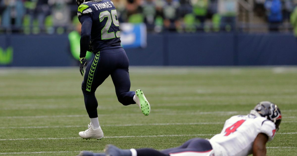 New Orleans Saints wide receiver Michael Thomas (13) applies a stiff arm to Seattle  Seahawks free safety Earl Thomas (29) en route to a 17 yard gain at the  Mercedes-Benz Superdome in