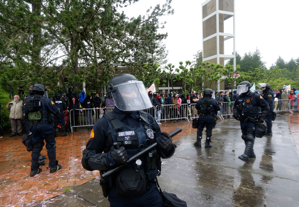 Washington state troopers stood between protesters with the conservative group Patriot Prayer and counterprotesters in June at The Evergreen State College. (AP Photo/Ted S. Warren)