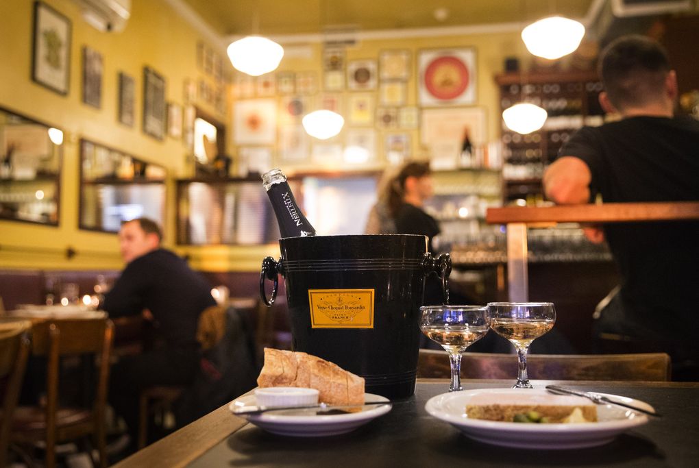 A bottle of bubbles and the excellent chicken liver terrine at lovely Seattle classic Le Pichet. (Lindsey Wasson / The Seattle Times)
