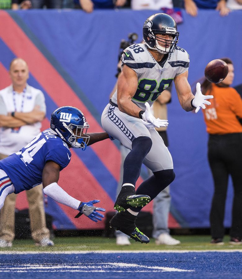 Jimmy Graham of the Seattle Seahawks watches from the sideline during