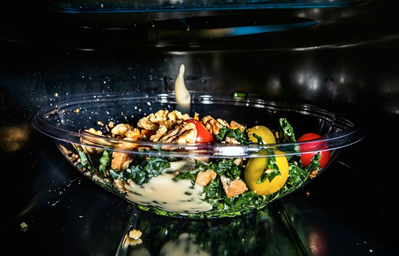 — PHOTO MOVED IN ADVANCE AND NOT FOR USE – ONLINE OR IN PRINT – BEFORE SUNDAY, OCT. 8, 2017. — Sally the Salad Robot at work in a restaurant in Palo Alto, Calif., Sept. 5, 2017. To reduce the risk of food-borne illness resulting from human contact at salad bars, Chowbotics founder Deepak Sekar invented a machine that assembles salads out of precut vegetables stored in canisters and chosen by diners using a touch screen. (Christie Hemm Klok/The New York Times)