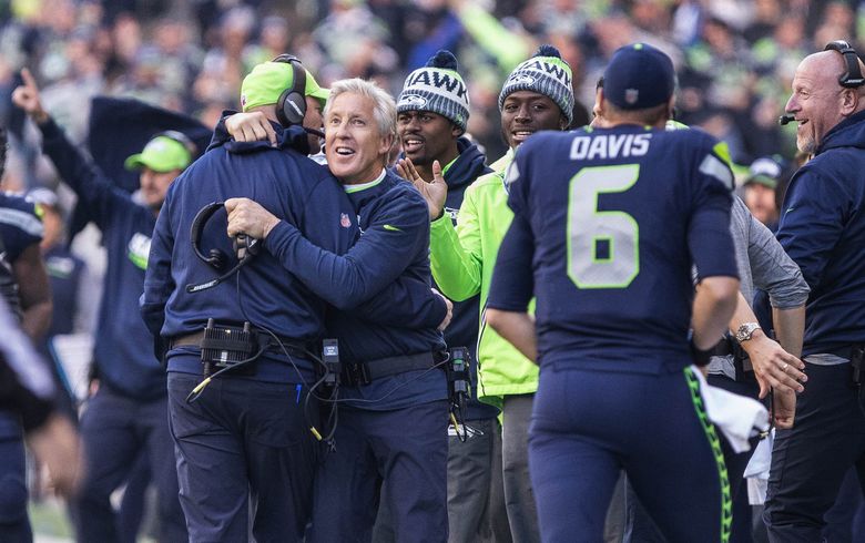 Jimmy Graham of the Seattle Seahawks watches from the sideline